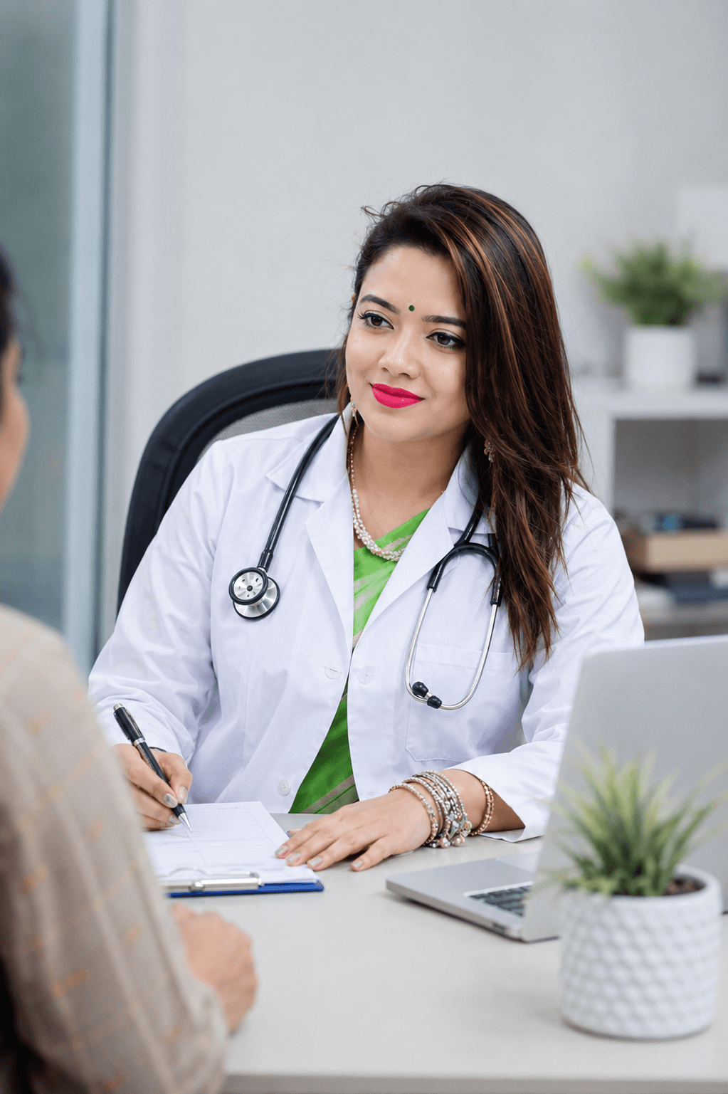 Dr. Rumpa at her desk reviewing patient records